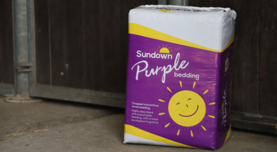 bale of Sundown Purple by a stable door