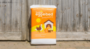 Egg-e-bed bale in front of a wooden door